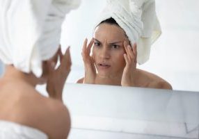 woman looking in mirror