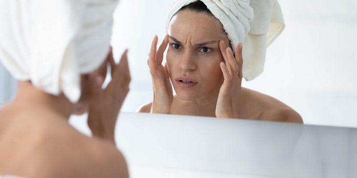 woman looking in mirror